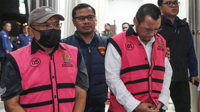 Direktur Pemasaran & Niaga PT Pertamina Tahun 2014 Hanung Budya (kiri) dan Direktur Gas, Pertochemical & New Business PT. Pertamina International Shipping Arif Sukmara (kanan) mengenakan rompi tahanan usai menjalani pemeriksaan di Gedung Kejaksaan Agung, Jakarta, Kamis (10/7/2025). [ANTARA FOTO/Asprilla Dwi Adha/bar]