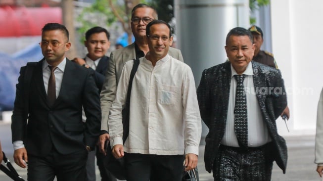 Mantan Menteri Pendidikan, Kebudayaan, Riset, dan Teknologi (Mendikbudristek) 2019-2024 Nadiem Makarim (tengah) bersama kuasa hukum Hotman Paris (kanan) tiba untuk memenuhi panggilan pemeriksaan di Jampidsus, Kejaksaan Agung, Jakarta Selatan, Selasa (15/7/2025). [Suara.com/Alfian Winanto]