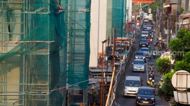 Suasana pembangunan proyek LRT Jakarta Fase 1B di kawasan Pasar Pramuka, Jakarta, Kamis (24/7/2025). [Suara.com/Alfian Winanto]