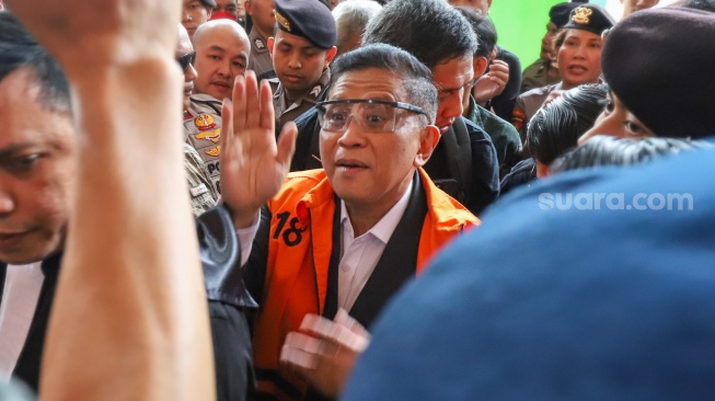 Terdakwa kasus dugaan suap dan perintangan penyidikan, Hasto Kristiyanto (tengah) saat datang untuk menjalani sidang putusan di Pengadilan Tipikor, Jakarta, Jumat (25/7/2025). [Suara.com/Alfian Winanto]