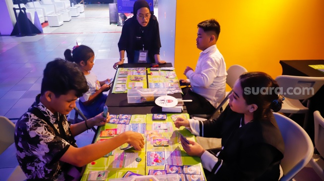 Pengunjung bermain Trading Card Game (TCG) dalam pameran Indonesia Game Week 2025 di Blok M Hub, Jakarta, Sabtu (9/8/2025). [Suara.com/Alfian Winanto]