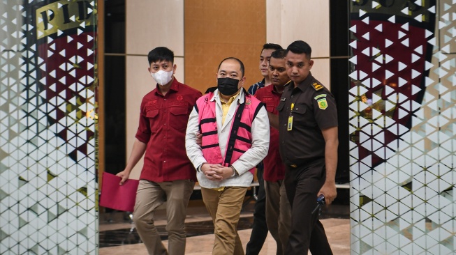 Tersangka kasus dugaan tindak pidana korupsi PT Sritex Iwan Kurniawan Lukminto (tengah) berjalan menuju mobil tahanan usai ditetapkan sebagai tersangka di Kejaksaan Agung, Jakarta, Rabu (13/8/2025). [ANTARA FOTO/Muhammad Adimaja/nym]