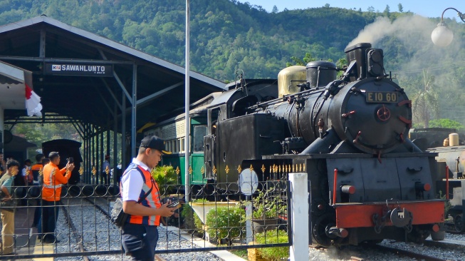 Lokomotif E1060 Mak Itam melaju dengan membawa wisatawan di Sawahlunto, Sumatera Barat, Selasa (26/8/2025). [ANTARA FOTO/Iggoy el Fitra/nym]
