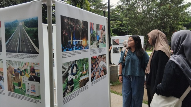 Pengunjung Saat Melihat Foto-foto di Pameran Foto PFI Bogor 'Satu Dekade PFI Bogor' di Alun-alun Kota Bogor [Andi/Suarabogor].