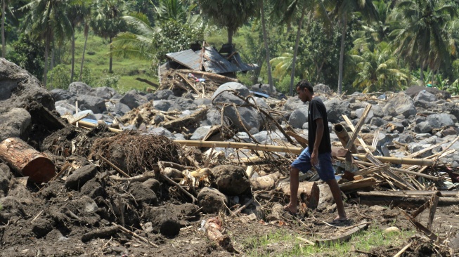 Warga melintas di lokasi bekas terjadinya banjir bandang Kabupaten Nagekeo, Nusa Tenggara Timur, Rabu (24/9/2025). [ANTARA FOTO/Mega Tokan/sgd/tom]