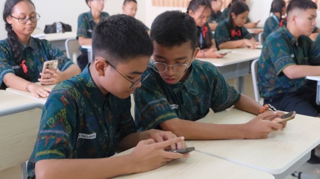 Siswa mengikuti pelajaran bahasa inggris dengan metode pembelajaran smart classroom atau ruang kelas pintar di SMP Negeri 15 Denpasar, Bali, Jumat (3/10/2025). [ANTARA FOTO/Nyoman Hendra Wibowo/YU]