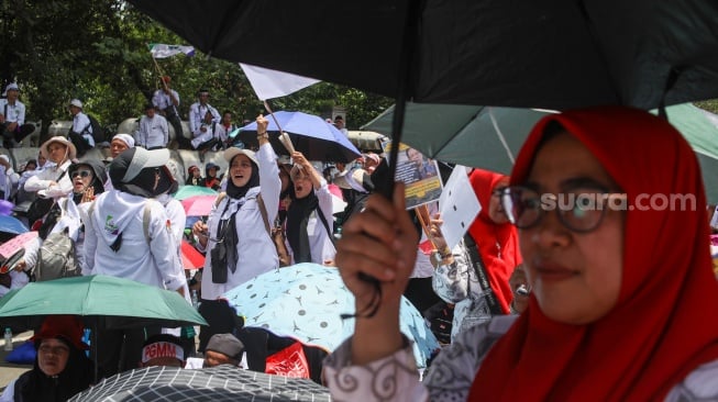 Guru honorer madrasah swasta dari berbagai wilayah di Indonesia berunjuk rasa di kawasan Monas, Jakarta, Kamis (30/10/2025). [Suara.com/Alfian Winanto]