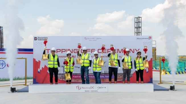 (Dari kiri ke kanan) VP Renewables Of Medco Power Indonesia  Adrianto Darmoyo, CFO Singtel Digital Infraco And Nxera Cyndi Pei, Direktur Strategic Business Development & Portfolio Telkom Indonesia Seno Soemadji, Direktur Utama Telkom Indonesia Dian Siswarini, CEO NeutraDC Group  Andreuw Th.A.F, CEO NeutraDC Nxera Batam Indrama YM Purba, Group Chief Corporate Officer Designate, Singtel Gan Siok Hoon saat melakukan simbolisasi Topping Off di atap gedung campus data center (BTM-1) NeutraDC Nxera Batam, pada Kamis, (30/10/2025) (Dok: Telkom)