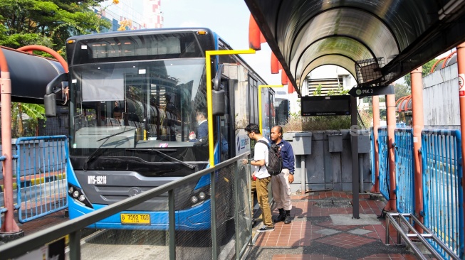 Penumpang menaiki Bus Transjakarta di Terminal Blok M, Jakarta, Sabtu (1/11/2025). [Suara.com/Alfian Winanto]