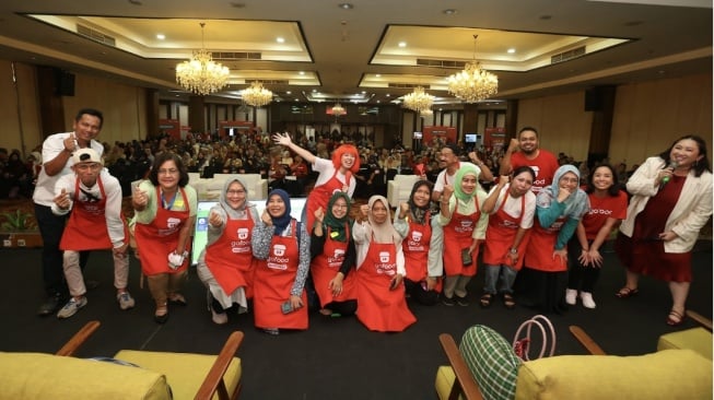 [Ujung kanan di sebelah MC] Siti Prameswari Wulandari, Head of Sales Excellence & Merchant Experience Gojek dan Deny Listiantoro, Kepala Seksi Pemberdayaan UKM, Dinas PPKUKM, Provinsi DKI Jakarta Provinsi DKI Jakarta [ujung kiri] berfoto bersama 10 pelaku UMKM kuliner,  pemenang yang paling cepat menyelesaikan pendaftaran di aplikasi GoFood Merchant dalam acara Maju Bersama GoFood di SMESCO, Jakarta (19/10/2025) (Dok: GoFood)