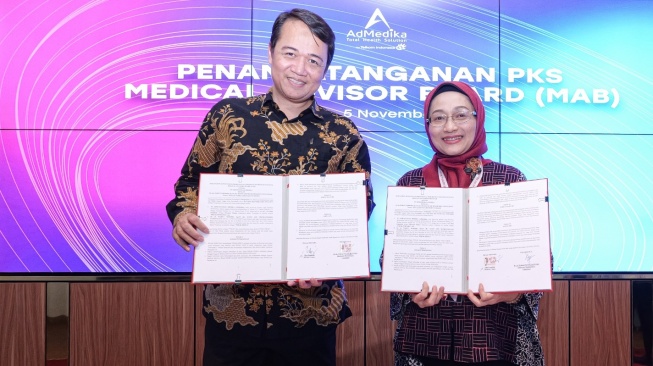Dr. dr. Wahyu Widodo, Sp.O.T, Subsp.T.L.B.M.(K), S.H (kiri) dan Direktur AdMedika Dian Prambini saat melakukan penandatanganan Perjanjian Kerja Sama (PKS) untuk penambahan Dewan Penasihat Medis (DPM) sebagai medical expert untuk Medical Advisor Board (MAB) AdMedika (Dok: Telkom)