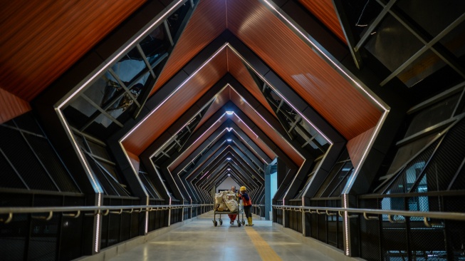 Pekerja membawa barang sisa material proyek saat uji coba Stasiun Rangkasbitung Ultimate di Lebak, Banten, Senin (24/11/2025). [ANTARA FOTO/Muhammad Bagus Khoirunas/agr]