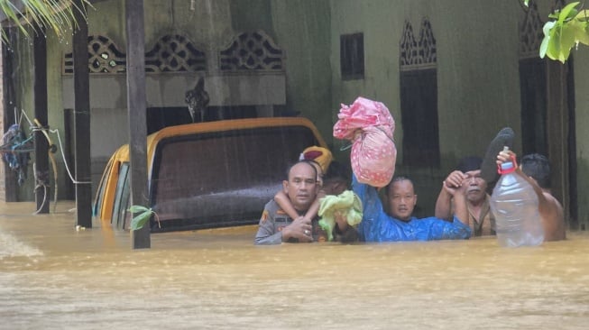 Polisi mengevakuasi warga yang terjebak banjir di Sumut. [dok Polda Sumut]