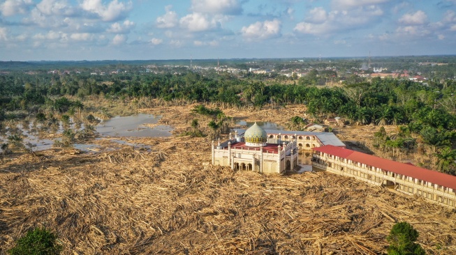 Foto udara menampilkan tumpukan kayu-kayu memenuhi area Pondok Pesantren Darul Mukhlishin pascabanjir bandang di Desa Tanjung Karang, Karang Baru, Kabupaten Aceh Tamiang, Aceh, Jumat (5/12/2025). [ANTARA FOTO/Erlangga Bregas Prakoso/app/foc]