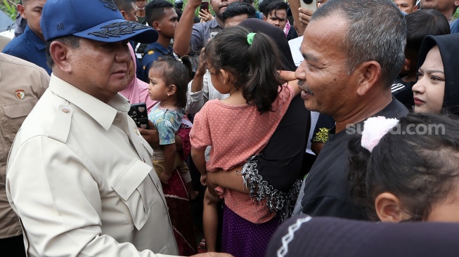 Presiden Prabowo Subianto (kiri) menyapa pengungsi di posko pengungsian Desa Belee Panah, Bireuen, Aceh, Minggu (7/12/2025). [ANTARA FOTO/Irwansyah Putra/nz]