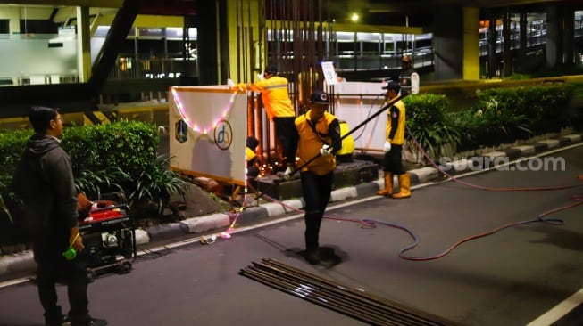 Petugas mengerjakan pembongkaran tiang monorel di Jalan H. R. Rasuna Said, Jakarta, Rabu (14/1/2026). [Suara.com/Alfian Winanto]