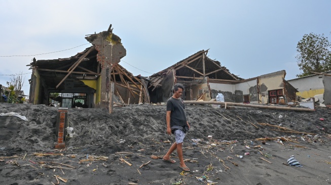 Warga berada dekat rumah yang rusak diterjang gelombang tinggi di pesisir kampung nelayan, Lingkungan Bugis, Ampenan, Mataram, NTB, Senin (26/1/2026). [ANTARA FOTO/Ahmad Subaidi/nz]
