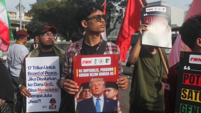 Sejumlah massa membentangkan poster saat mengikuti aksi solidaritas untuk Iran di depan Kedubes Amerika di Jakarta, Selasa (3/3/2026). [Suara.com/Alfian Winanto]