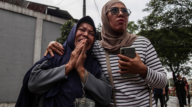 Keluarga korban bencana longsor gunungan sampah menangis saat berada di Tempat Pengolahan Sampah Terpadu (TPST) Bantargebang, Bekasi, Jawa Barat, Senin (9/3/2026). [ANTARA FOTO/Darryl Ramadhan/wsj]