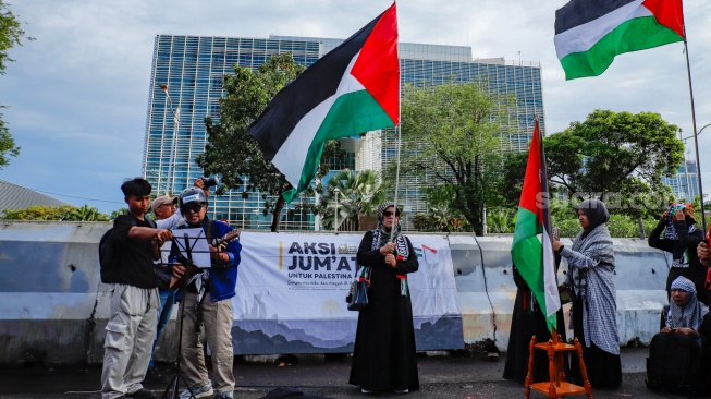 Massa menggelar Aksi Jumat untuk Palestina di depan Kedutaan Besar Amerika Serikat, Jakarta, Jumat (10/4/2026). [Suara.com/Alfian Winanto]
