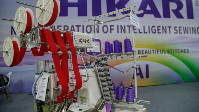 Petugas memeragakan cara penggunaan mesin jahit berteknologi AI dalam pameran Indo Intertex–Inatex 2026 di JIExpo Kemayoran, Jakarta, Kamis (16/4/2026). [Suara.com/Alfian Winanto]