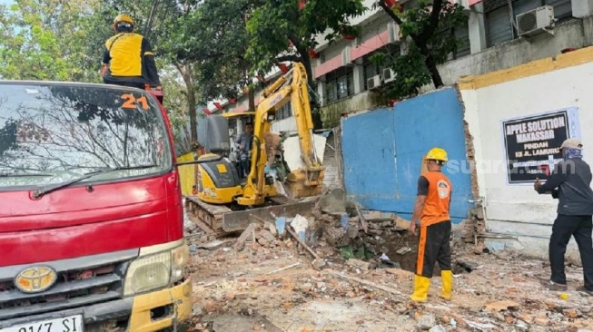 Pemerintah provinsi Sulawesi Selatan dan Pemerintah Kota Makassar melakukan penertiban terhadap puluhan lapak PK5 di samping SMKN 4 Makassar, Kamis (23/4) [SuaraSulsel.id/Lorensia Clara]