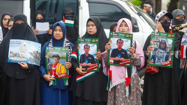 Massa yang berasal dari Aliansi kemanusiaan Aqsa Working Group (AWG) membawa poster bertema penculikan aktivis oleh zionis saat Aksi Jumat untuk Palestina di depan Kedutaan Besar Amerika Serikat, Jakarta, Jumat (22/5/2026). [Suara.com/Alfian Winanto]