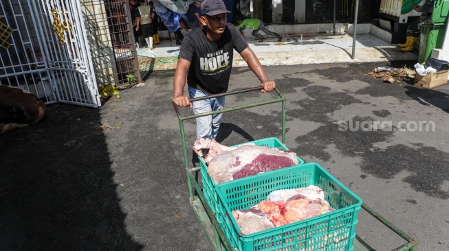 Petugas memotong daging hewan kurban di Masjid Sunda Kelapa, Jakarta, Rabu (27/5/2026). [Suara.com/Alfian Winanto]