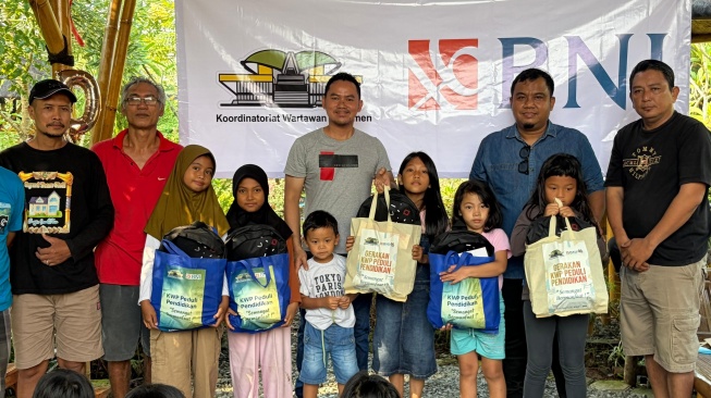 Ketua Koordinatoriat Wartawan Parlemen, Ariawan, saat membagikan bantuan sekolah kepada anak-anak, dalam program 'KWP Berbagi! KWP Peduli Pendidikan', Kamis (11/6/2026).