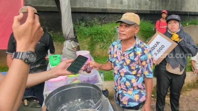 Pedagang kaki lima ikut meraup rezeki tak terduga setelah seluruh dagangan mereka diborong habis oleh peserta aksi. (Suara.com/Adiyoga)