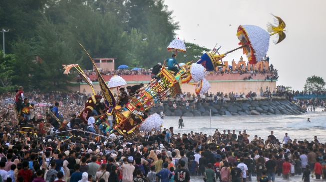 Warga menaiki Tabuik saat dibuang ke laut pada puncak Pesona Budaya Hoyak Tabuik 2026 di Pantai Gandoriah, Pariaman, Sumatera Barat, Minggu (28/6/2026). [ANTARA FOTO/Fitra Yogi/sgd]