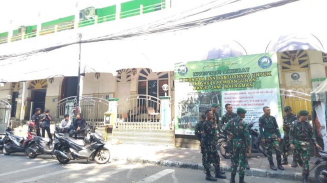 Aparat berjaga di sekitar Jalan Tambak Menteng pada Minggu (26/7/2026). (Suara.com/ Alif Bintang)
