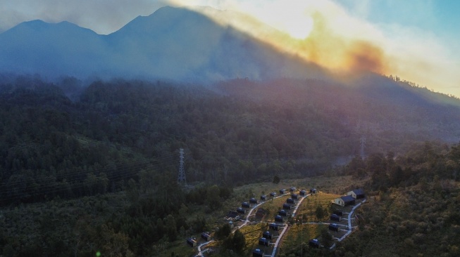 Foto udara kebakaran terjadi di Gunung Merapi Ungup-ungup terlihat dari Gunung Rante, Banyuwangi, Jawa Timur, Jumat (4/9/2026). [ANTARA FOTO/Budi Candra Setya/sgd]
