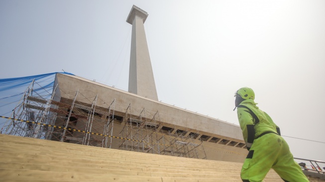 Pekerja membersihkan salah satu sisi Tugu Monumen Nasional (Monas) di Jakarta, Rabu (9/9/2026). [Suara.com/Alfian Winanto]