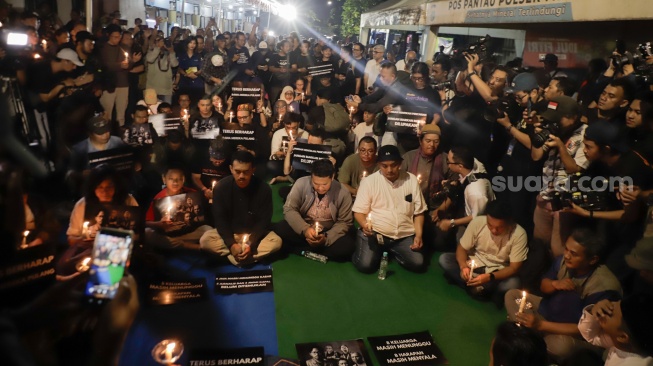 Sejumlah anggota Pewarta Foto Indonesia (PFI) dan jurnalis menggelar doa bersama di Bundaran HI, Jakarta, Jumat (11/9/2026). [Suara.com/Alfian Winanto]