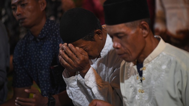 Sejumlah warga berdoa bersama untuk keselamatan lima jurnalis dan tiga awak kapal yang hilang kontak saat liputan erupsi Gunung Anak Krakatau di Dermaga Marina Carita, Pandeglang, Banten, Jumat (11/9/2026). [ANTARA FOTO/Aditya Pradana Putra/wsj]