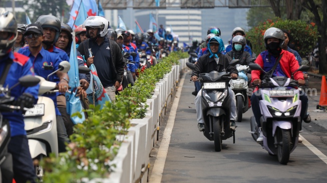 Massa buruh melakukan long march saat aksi unjuk rasa di Kawasan Bundaran HI, Jakarta, Kamis (24/9/2026). [Suara.com/Alfian Winanto]