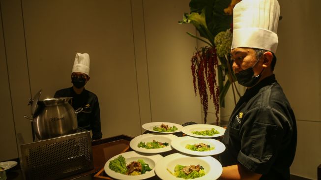 Pramusaji membawakan makanan untuk dihidangkan di Roemah Umara, Jakarta, Kamis (8/10/2026). [handout]