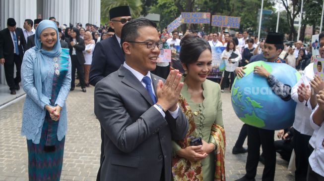 Pejabat lama Menteri Luar Negeri Sugiono didampingi istrinya Marlyn Maisarah menyapa pegawai Kementerian Luar Negeri dalam acara pisah sambut pejabat baru dan lama di Gedung Pancasila, Kementerian Luar Negeri, Jakarta, Senin (12/10/2026). [Suara.com/Alfian Winanto]
