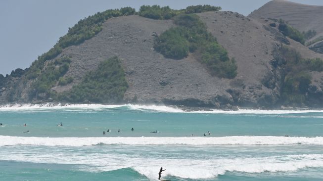 Sejumlah wisatawan bermain selancar di Pantai Tanjung Aan, Kawasan Ekonomi Khusus (KEK) Mandalika, Lombok Tengah, NTB, Selasa (13/10/2026). [ANTARA FOTO/Fikri Yusuf/tom]