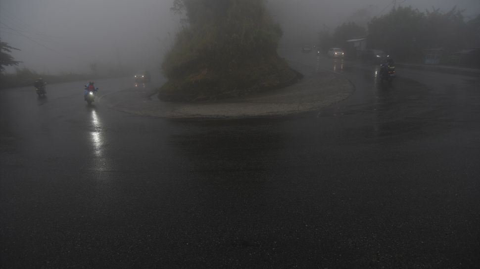 Kendaraan melintasi jalan yang tertutup kabut di Jalur Trans Sulawesi Kawasan Pegunungan Kebun Kopi di Kabupaten Parigi Moutong, Sulawesi Tengah, Sabtu (30/4/2022). [ANTARA FOTO/Mohamad Hamzah/hp]