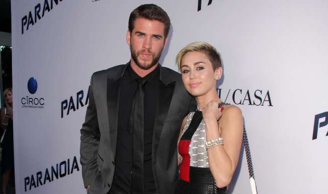 Liam Hemsworth and Miley Cyrus at the "Paranoia" US Premiere, Directors Guild of America, Los Angeles, CA 08-08-13