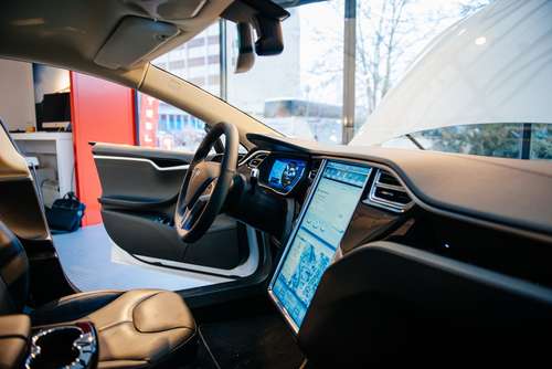 PARIS, FRANCE - NOVEMBER 29, 2014: The interior of a Tesla Motors Inc. Model S electric vehicle with its large touchscreen dashboard.