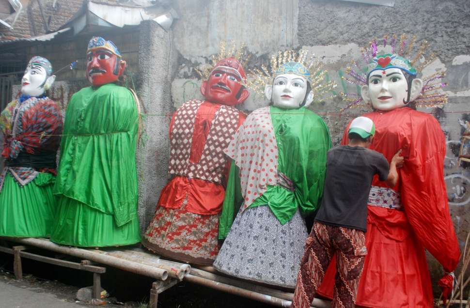 Perajin menyelesaikan pembuatan Ondel-ondel boneka khas Betawi di Kramat Pulo, Jakarta, Selasa (18/7). 