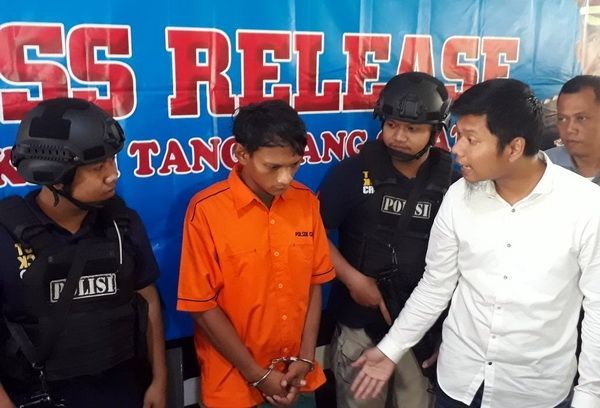 MI (35), pelaku pembongkaran makam dan pencurian tali pocong jenazah almarhum M. Hendra, di Polres Tangerang Selatan, Senin (8/1/2018). [Suara.com/Welly Hidayat]