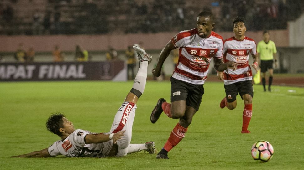 Pemain Madura United, Greg Nwokolo, berusaha melewati hadangan pemain Bali United, Agus Nova Wiantara, dalam laga perempat final Piala Presiden 2018 di Stadion Manahan, Solo, Sabtu (3/2/2018). [Antara/Mohammad Ayudha]