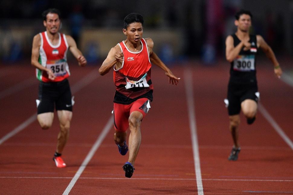 Sprinter Indonesia Sapto Yogo Purnomo (tengah) berlari dalam final 100 meter putra T37 Asian Para Games di Stadion Utama Gelora Bung Karno, Senayan, Jakarta, Selasa (9/10). Sapto berhasil meraih medali emas dengan catatan waktu 11,49 detik. ANTARA FOTO/Sigid Kurniawan