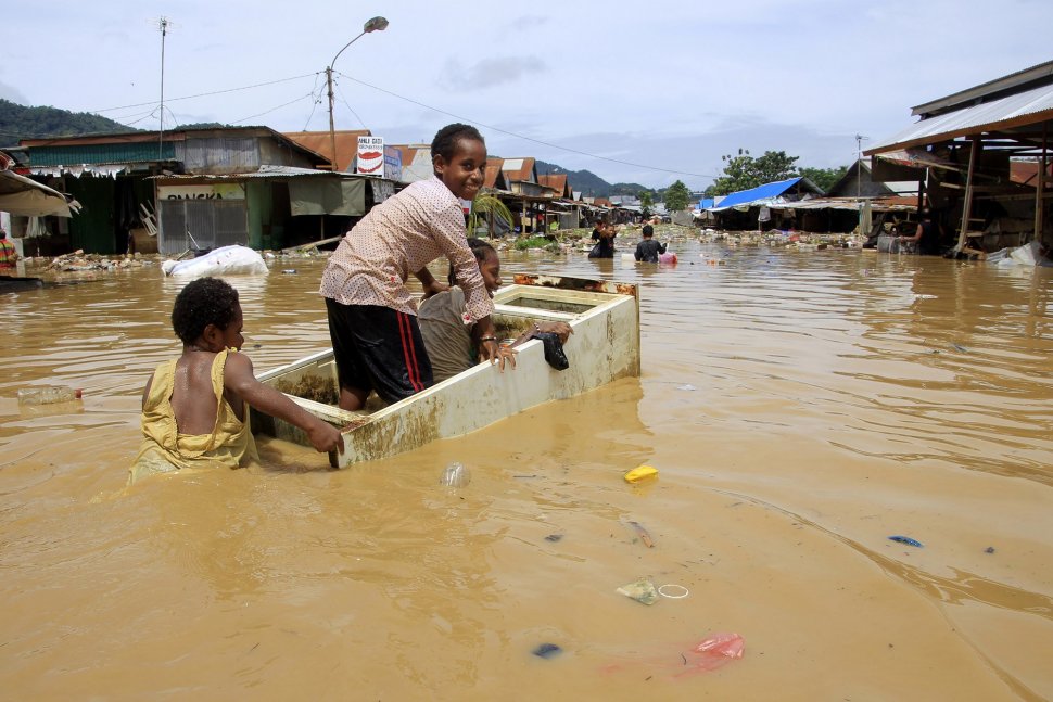 Sejumlah warga melintas saat banjir merendam kompleks Pasar Youtefa, Abepura, Jayapura, Papua, Sabtu (23/2). ANTARA FOTO/Gusti Tanati/sgd/foc.