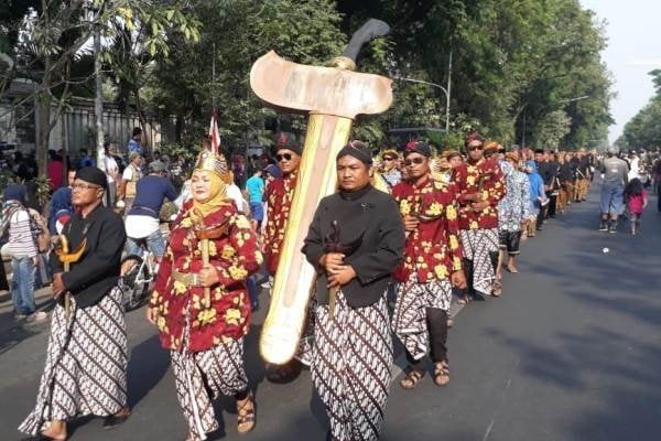 Peserta kirab mengusung keris hibah dari Presiden Joko Widodo, Kyai Tengara pada Kirab 1001 Keris melintasi area car free day (CFD), Jl. Slamet Riyadi, Solo, Minggu (15/9/2019). [Nicolaus Irawan - Solopos]