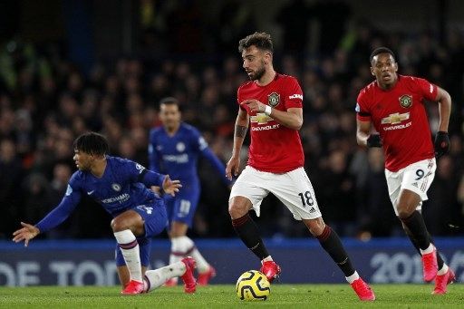 Pemain Manchester United Bruno Fernandes menggiring bola melewati pemain Chelsea dalam pertandingan Liga Inggris yang digelar di Stamford Bridge, 17 Februari 2020. [AFP]